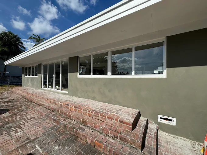 Professional stucco repair service in Boca Raton, Florida, restoring exterior walls with cracks, damage, and water stains for a smooth, modern finish.